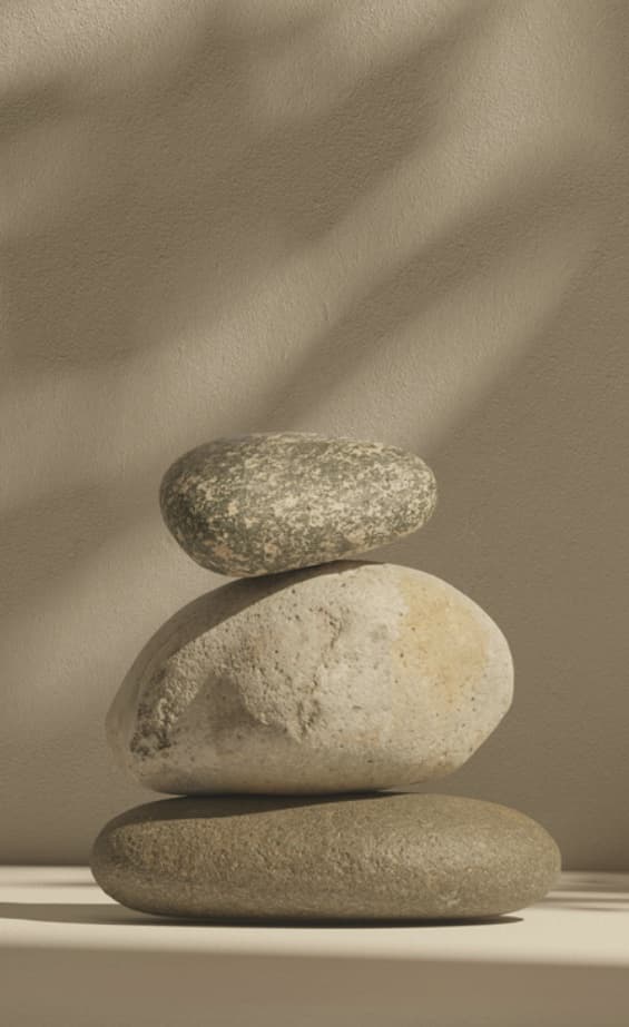 Three smooth stones balanced one on another